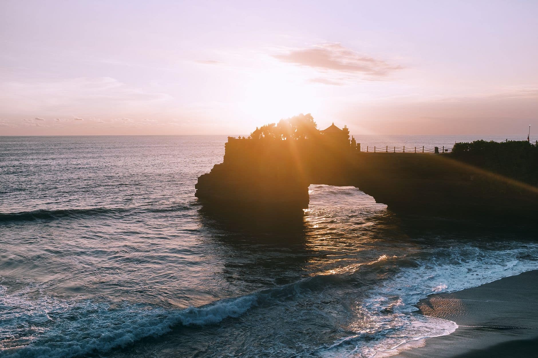 Tanah Lot sea temple silhouetted at sunset in Bali